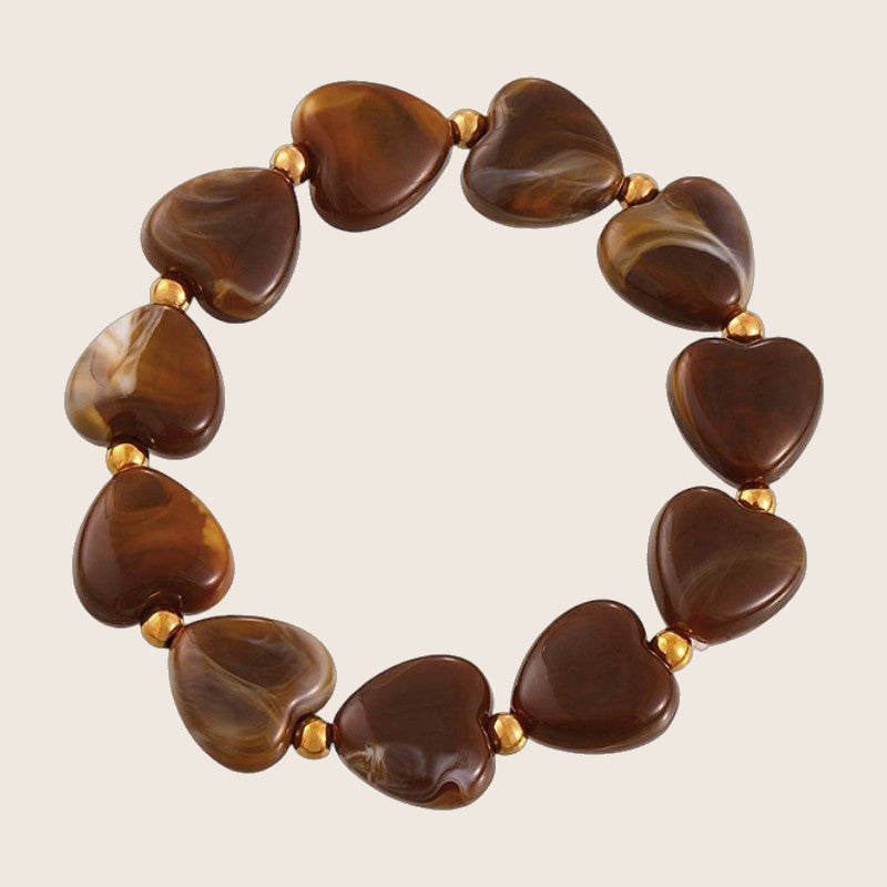 Bracelet à perles coeur en résine marbrée, intercalaires dorées en acier, modèle Aroba — photo 1