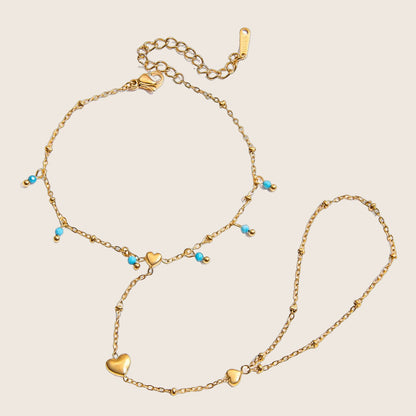 Bijou de main pour femme, acier inoxydable doré à perles turquoise et chaînette cœur, modèle Cigara — photo 1