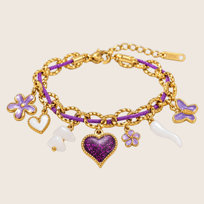 Bracelet à charms ajustable, chaîne dorée et cordon nylon violet, cœur pailleté, fleurs et papillons émaillés, modèle Neyma — photo 1