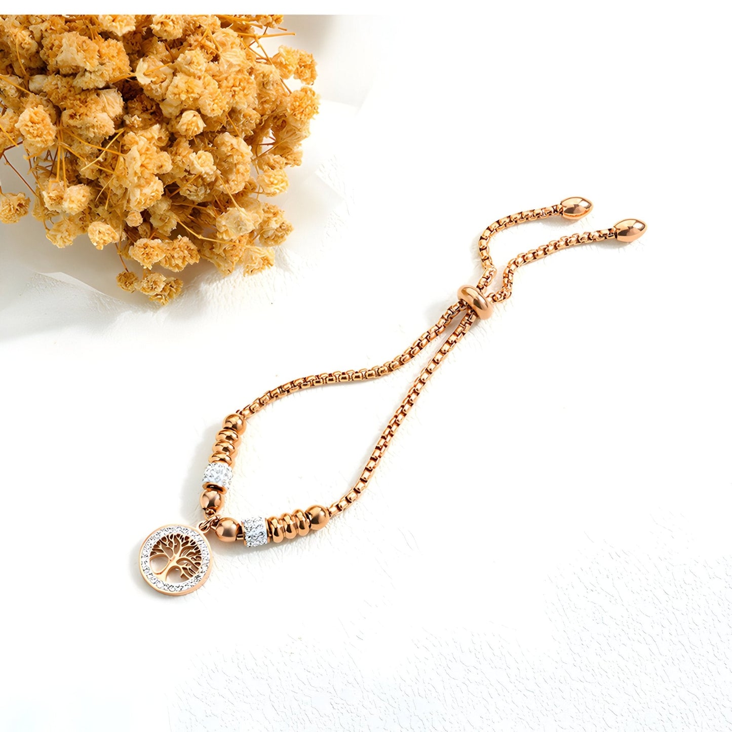 Bracelet en maille fine or rosé avec pendentif arbre de vie et zircon synthétique blanc.