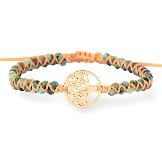 Bracelet en pierres de jaspe beige et marron tressées avec arbre de vie doré au centre.